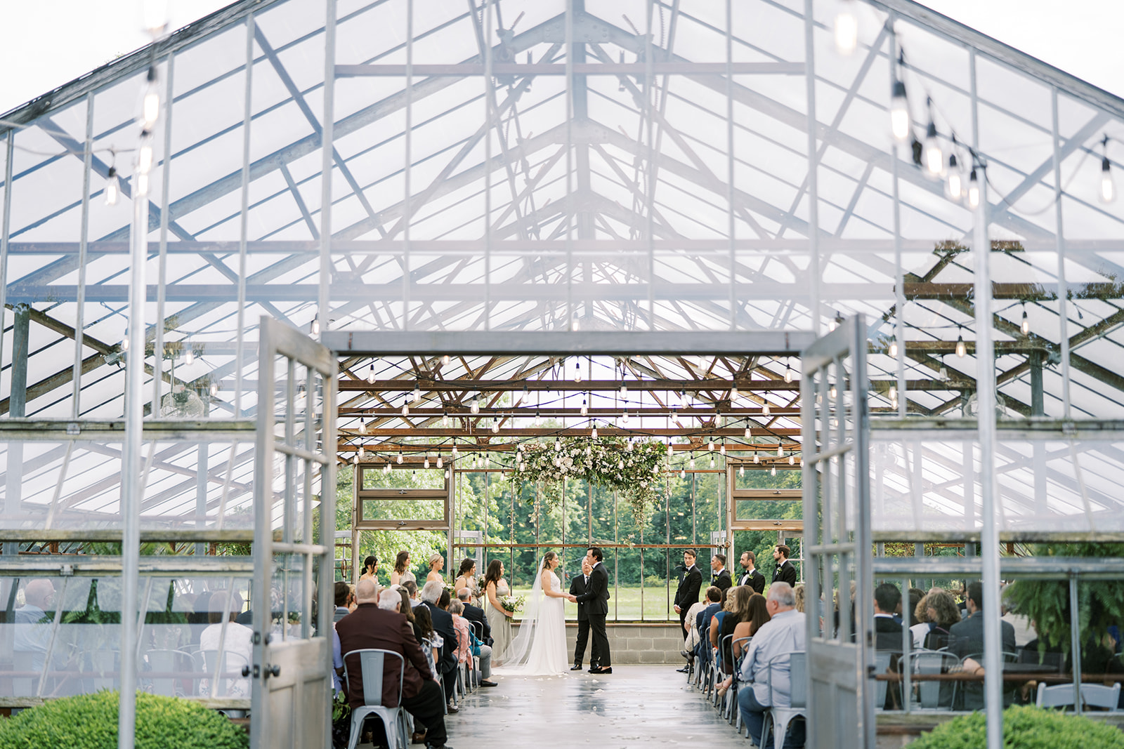 Ceremony inside greenhouse at Jorgensen Farm Oak Grove