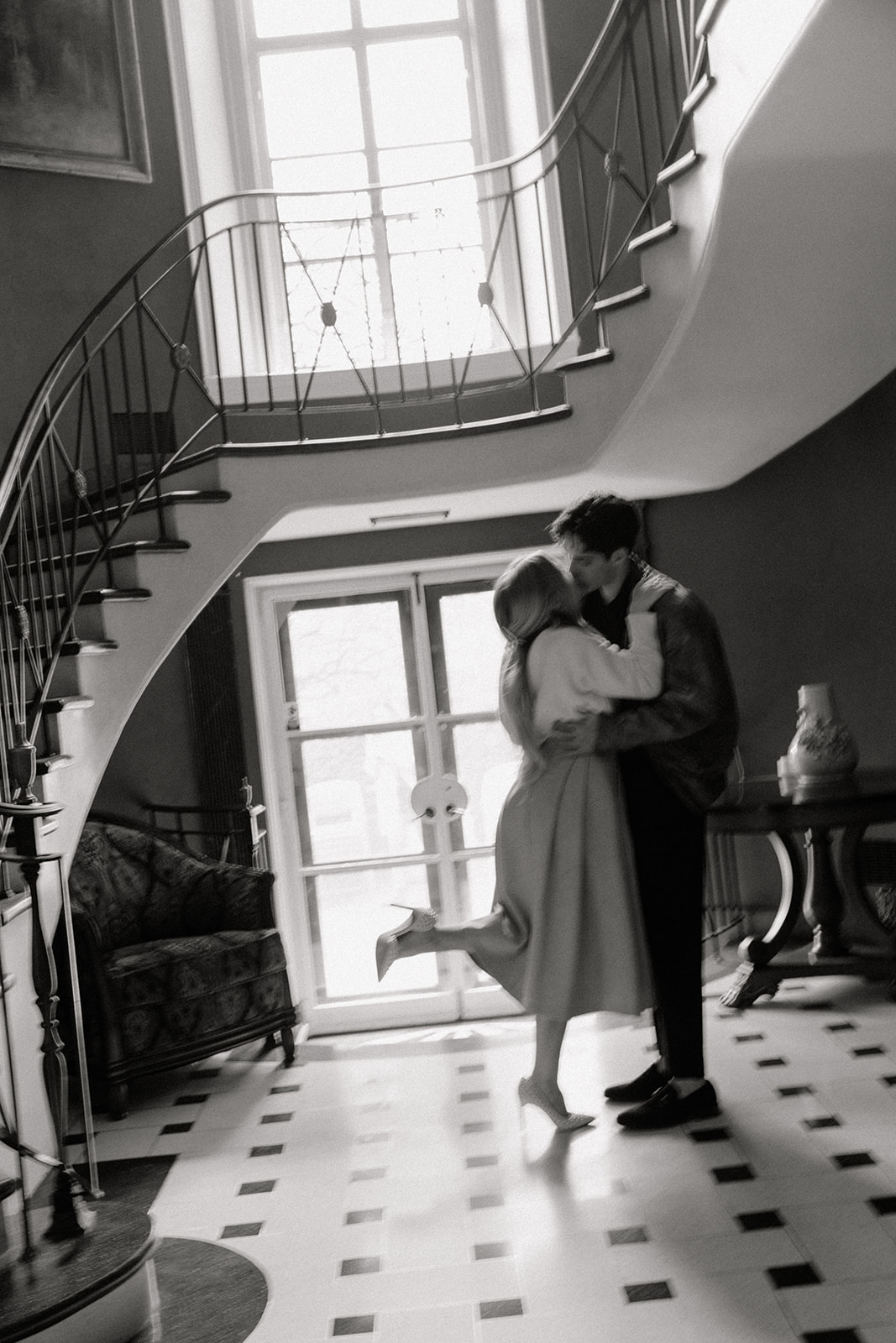 engaged couple at Greencrest Manor on the stairs inside the foyer