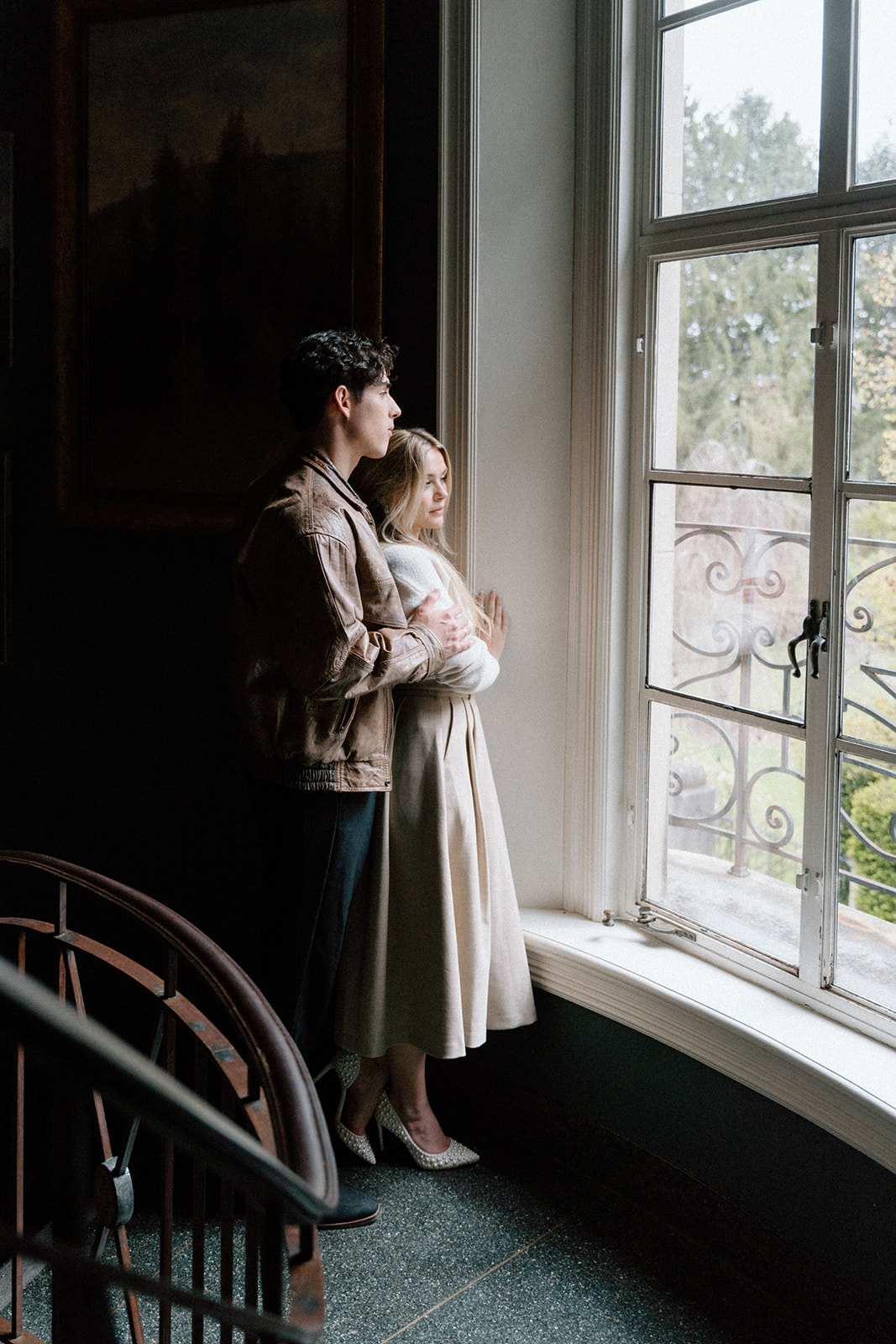 engaged couple at Greencrest Manor on the stairs inside the foyer