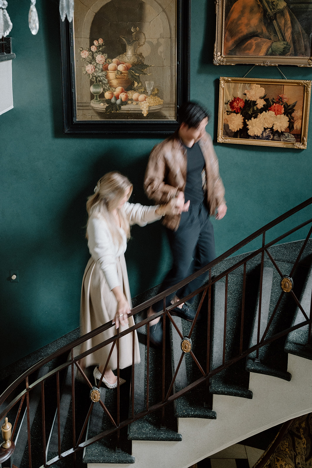 engaged couple at Greencrest Manor on the stairs inside the foyer