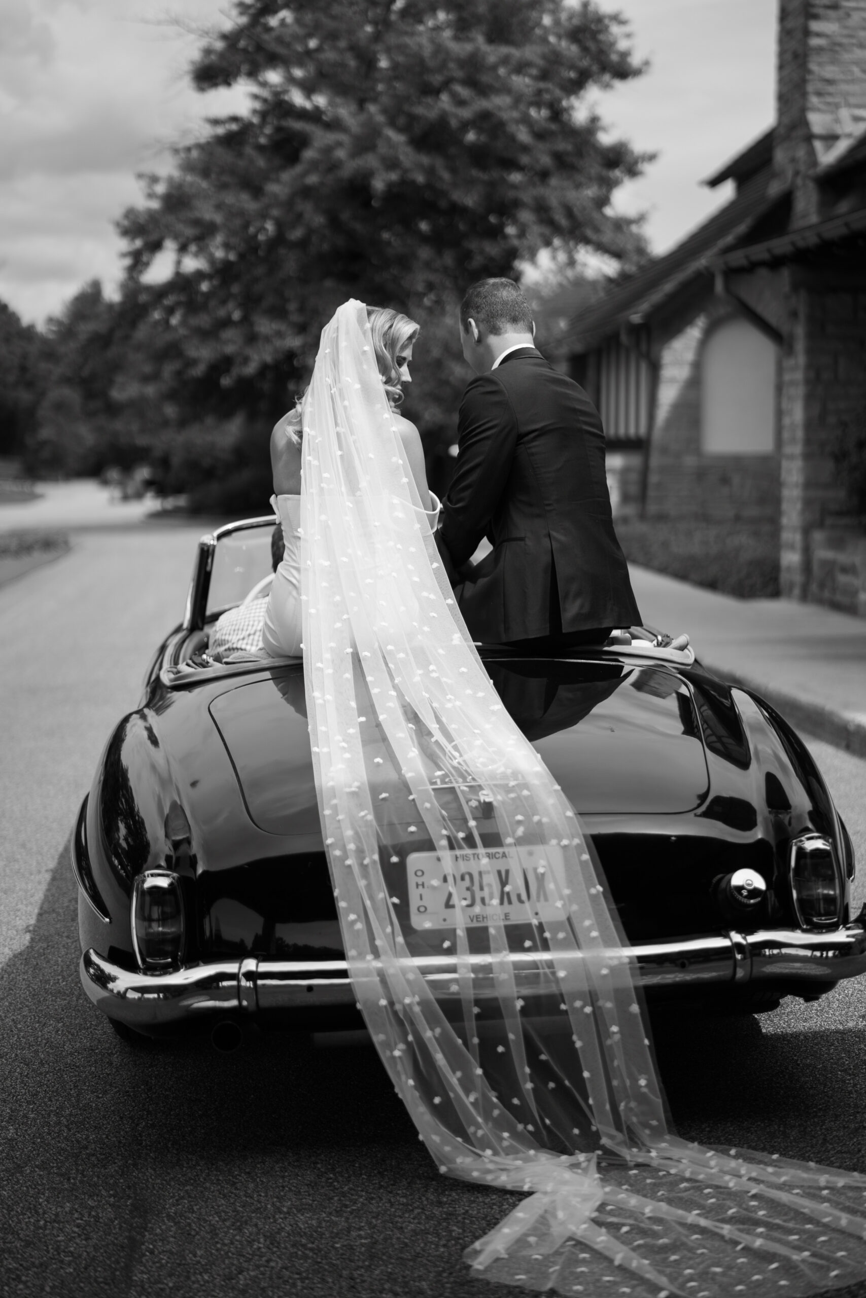 Bride and groom at Kirtland Country Club in vintage car