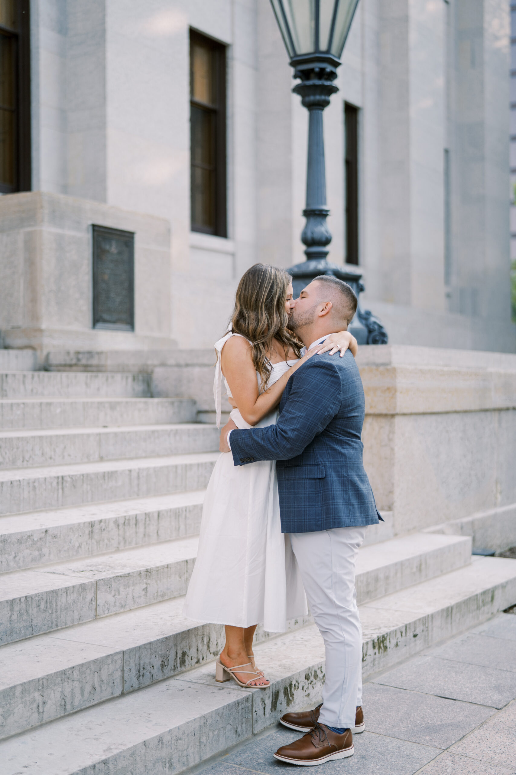Engagement photos at the Ohio Statehouse, couple on stairs